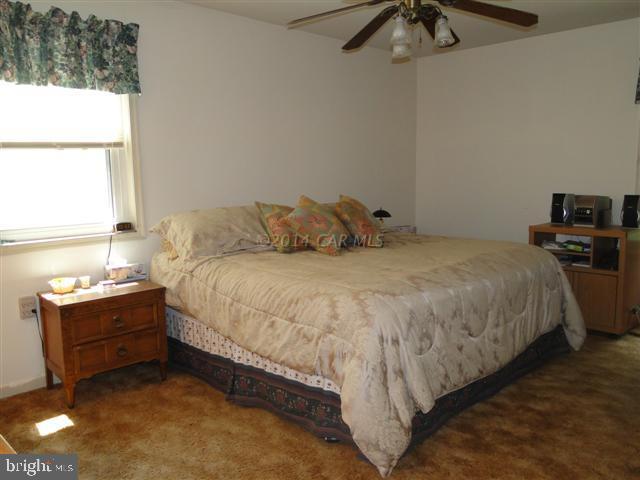 172 Windjammer Road Ocean Pines, MD 21811 - Photo 7 of 24 a large bed sitting in a bedroom next to a window