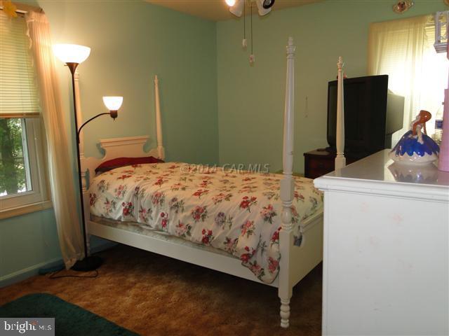 172 Windjammer Road Ocean Pines, MD 21811 - Photo 8 of 24 a bedroom with a bed and a flat tv screen on the dresser