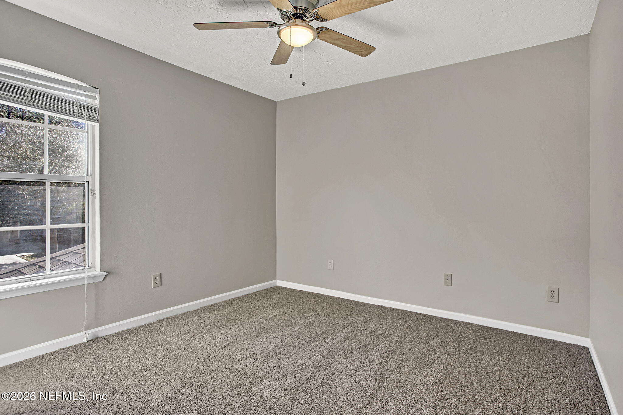 900 Country Bridge Road, Unit 3 St. Johns, FL 32259 - Photo 13 of 18 an empty room with a window and a fan