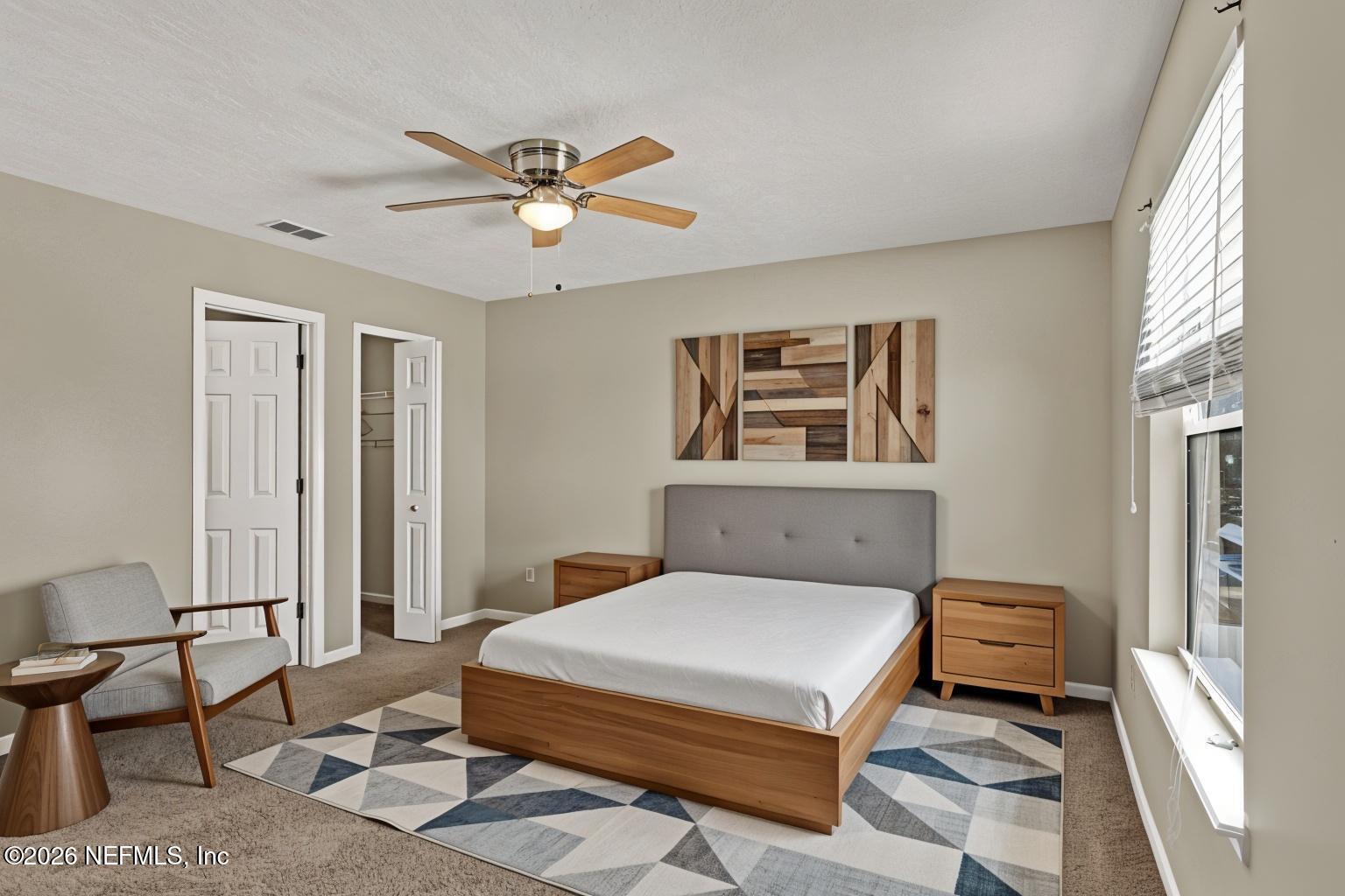 900 Country Bridge Road, Unit 3 St. Johns, FL 32259 - Photo 9 of 18 a bedroom with a bed and a chandelier