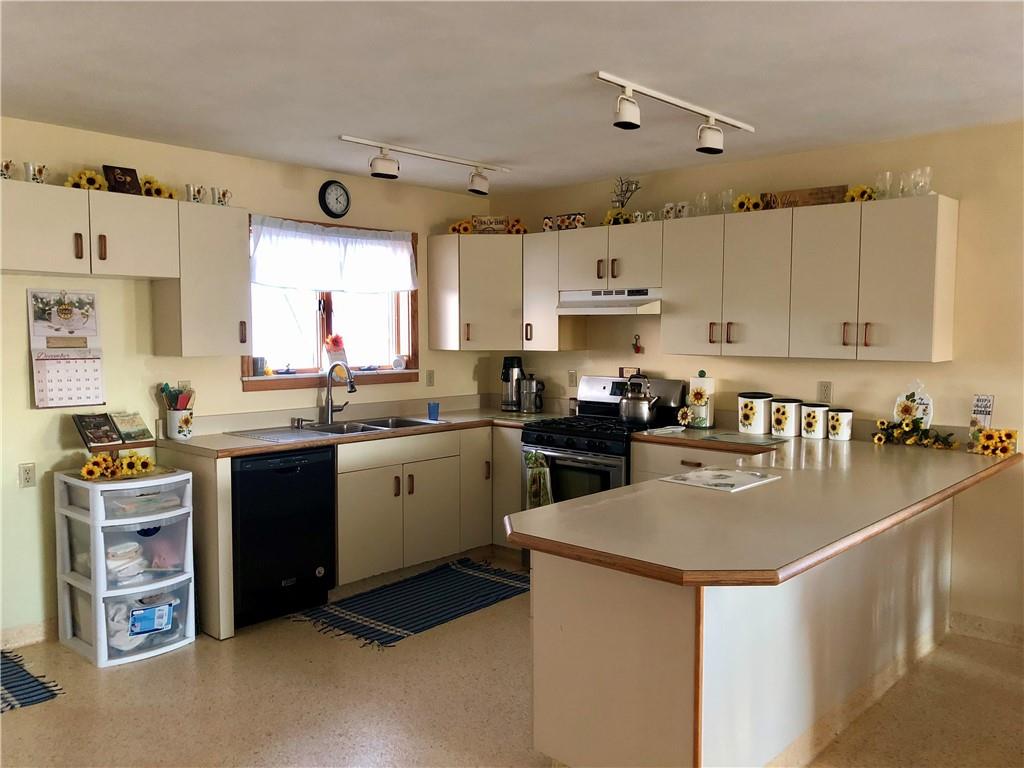 1683 Historical Road Northern Cambria, PA 15714 - Photo 3 of 17 a kitchen with a sink a stove a refrigerator and cabinets
