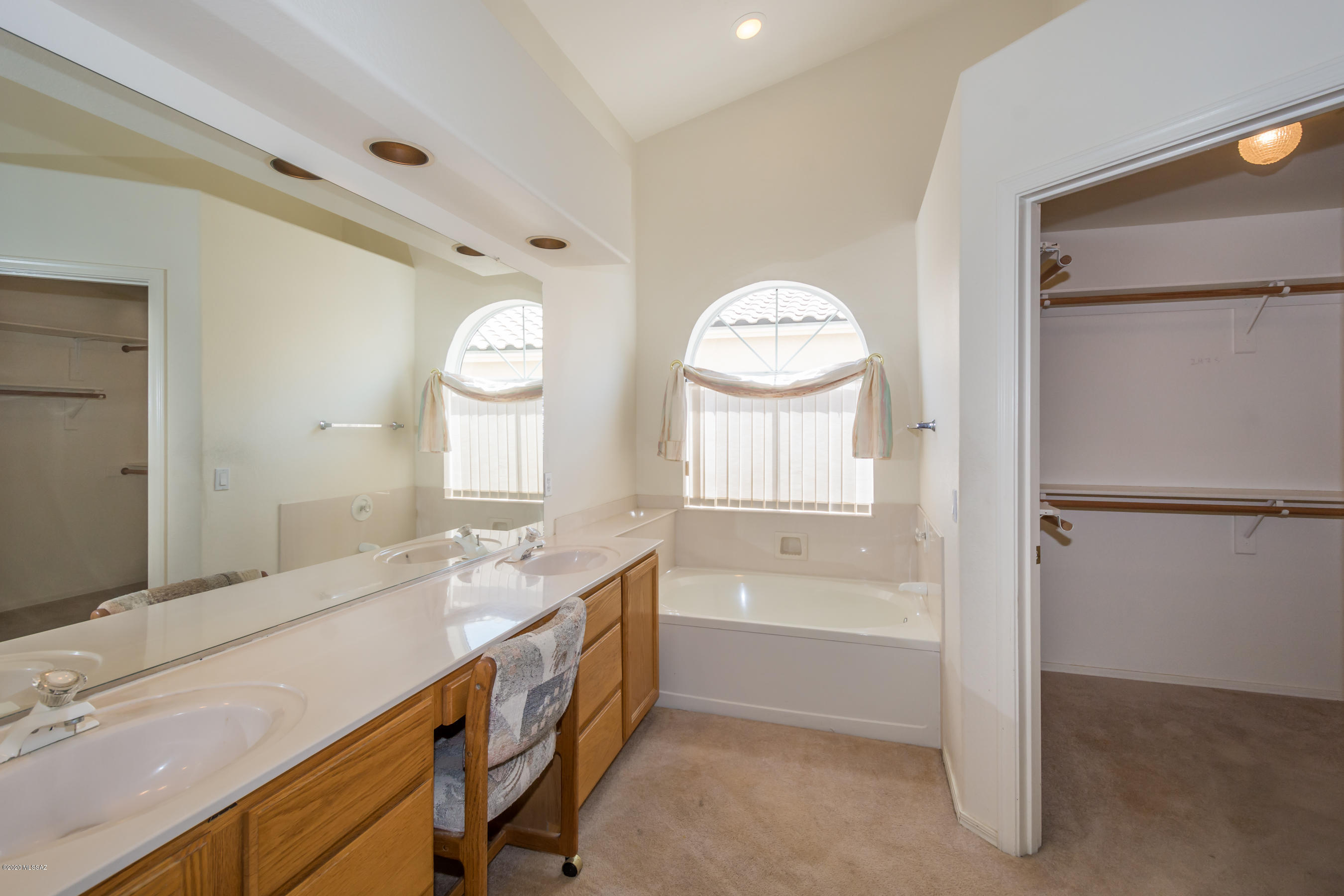 11341 Silver Pheasant Loop Oro Valley, AZ 85737 - Photo 18 of 41 a bathroom with a tub sink and a mirror