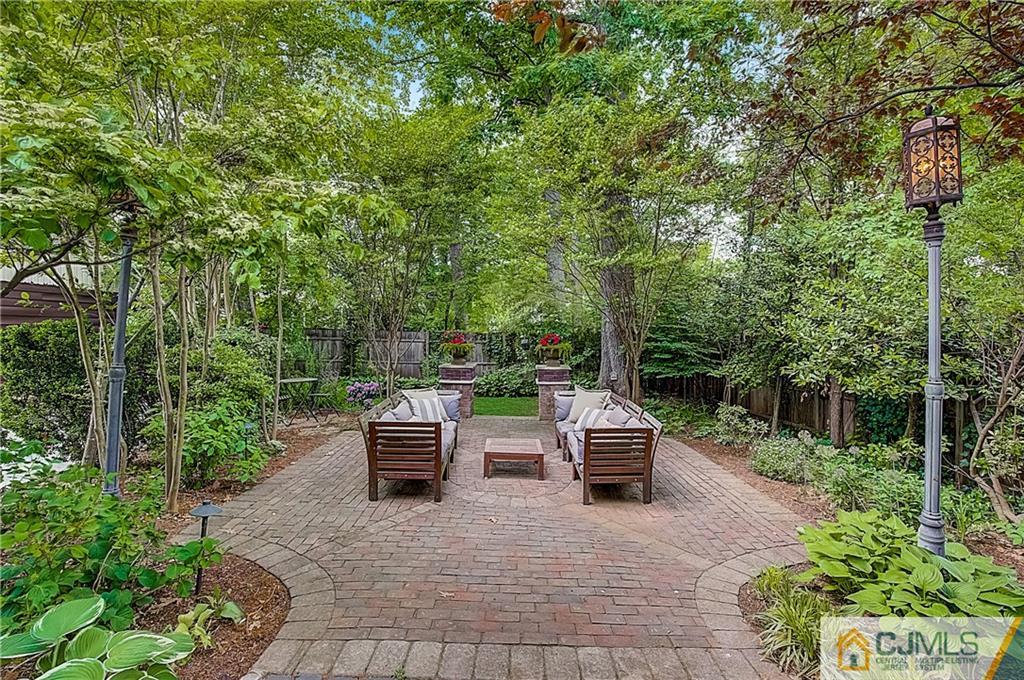 270 Middlesex Avenue Metuchen, NJ 08840 - Photo 42 of 54 a view of a patio with table and chairs potted plants and large trees