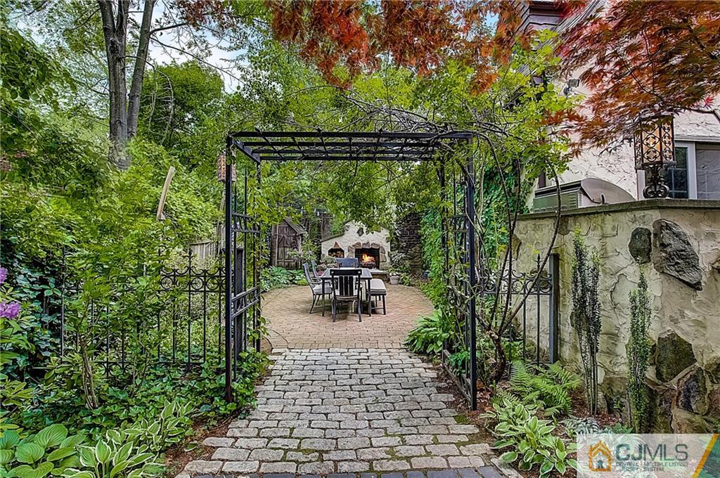 270 Middlesex Avenue Metuchen, NJ 08840 - Photo 44 of 54 a view of a patio with table and chairs potted plants with large tree