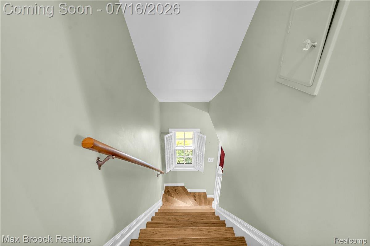 1292 Yorkshire Road Birmingham, MI 48009 - Photo 18 of 47 Staircase featuring wood-finish treads, a wood handrail, and white risers