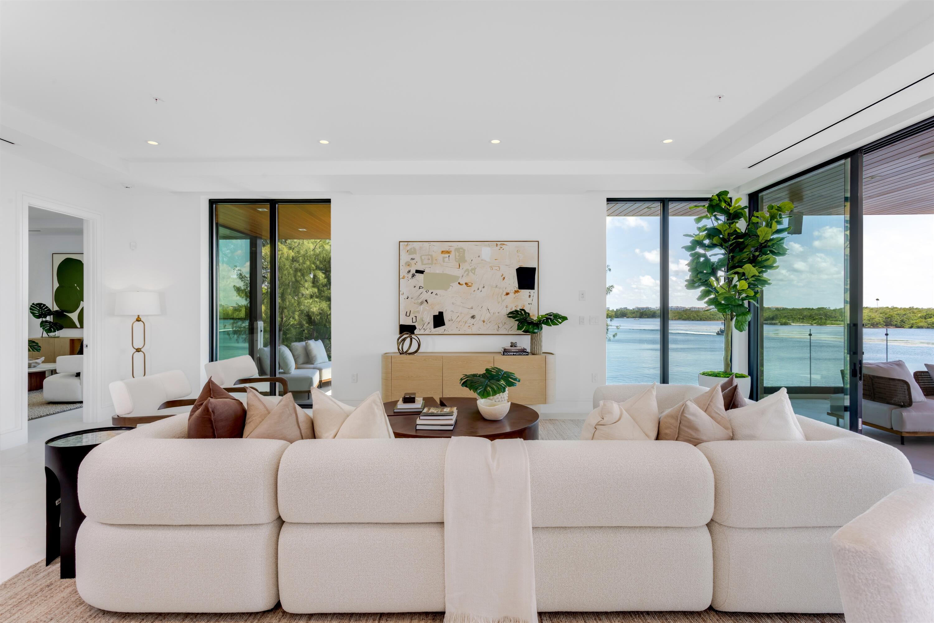 900 Lago Mar Lane, Unit PH Boca Raton, FL 33431 - Photo 7 of 58 a living room with furniture large windows and wooden floor