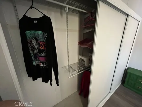 an empty room with closet and a ceiling fan