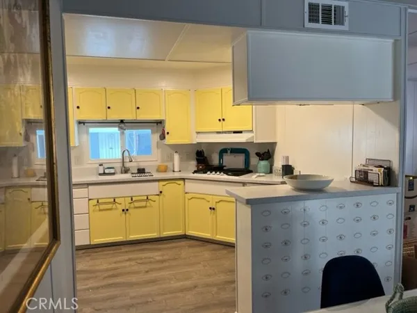 a kitchen with a sink cabinets and window