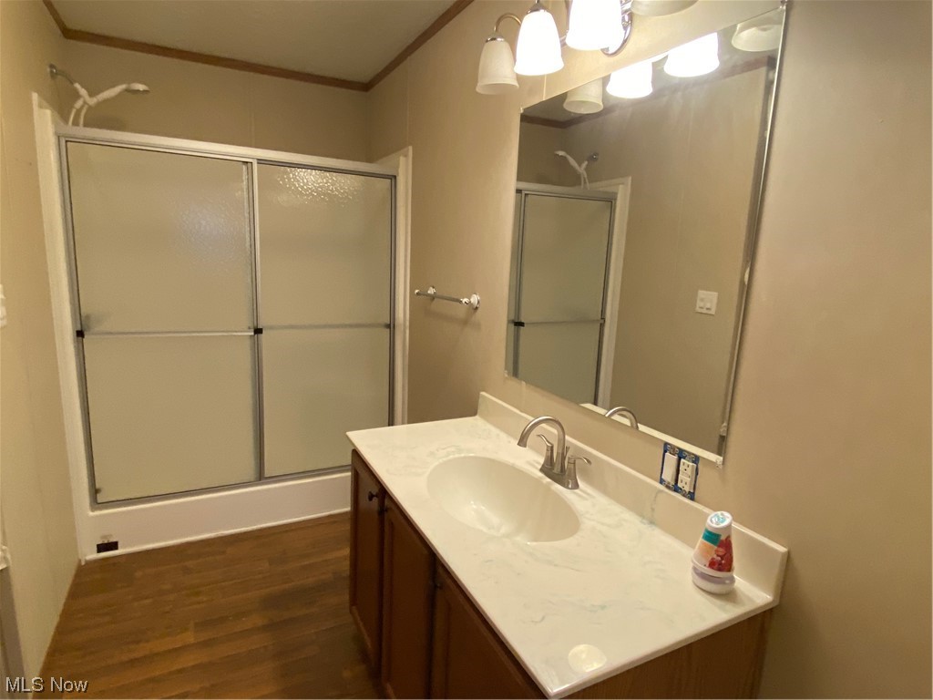 85 Rains Circle Zanesville, OH 43701 - Photo 14 of 15 Bathroom with hardwood / wood-style flooring, vanity, and ornamental molding. Nice big walk-in shower