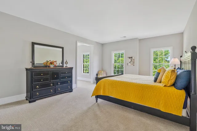 an aerial view of residential house with outdoor space and trees all around