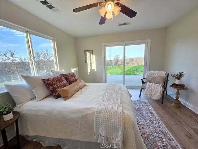 a large bedroom with a bed and large windows