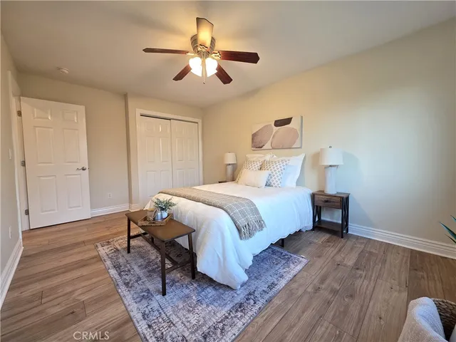 a bedroom with a bed and wooden floor