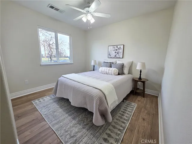 a bedroom with a large bed and a window