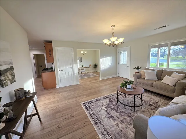 a living room with furniture and a chandelier
