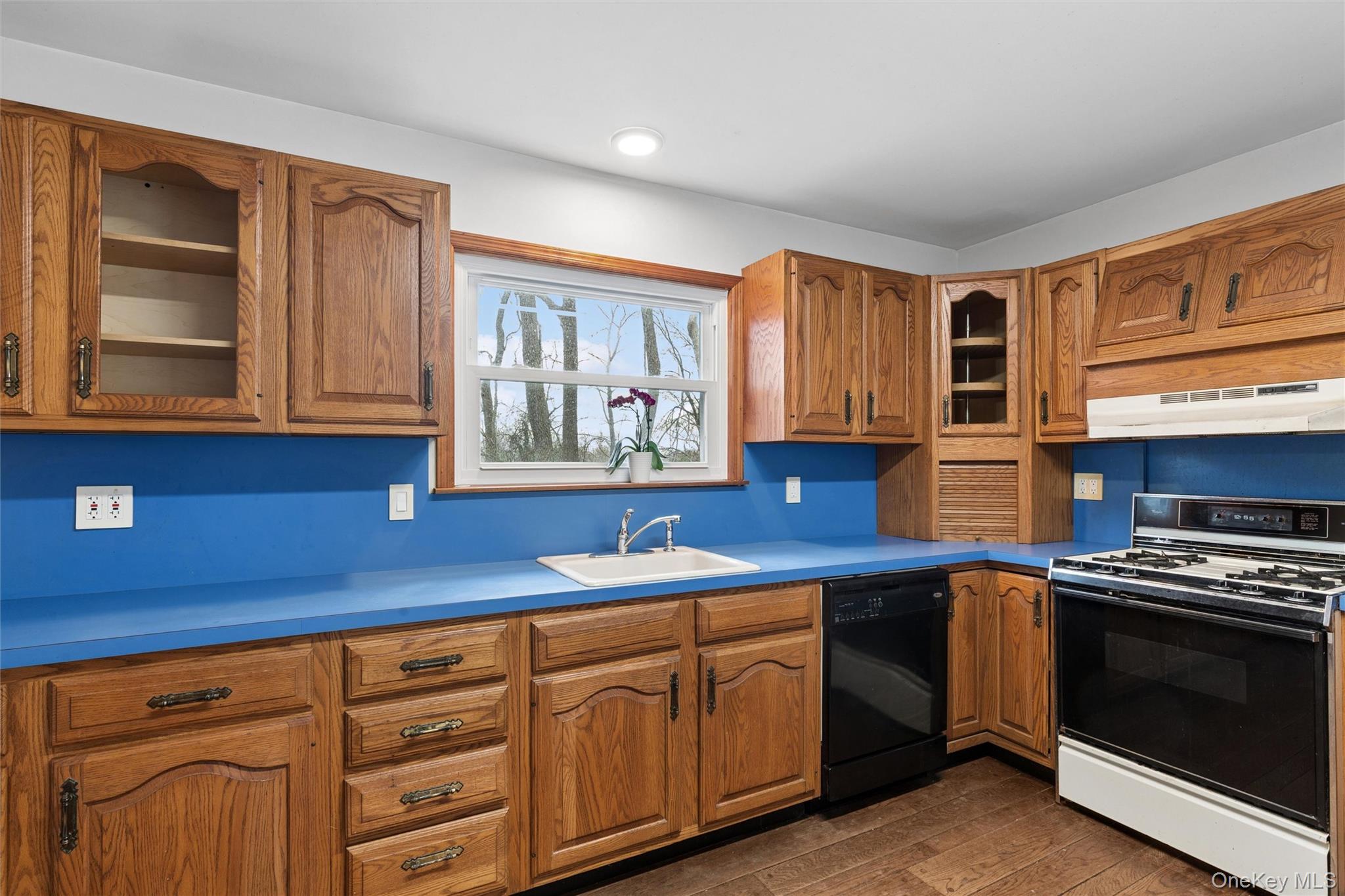 49 Overhill Road Wading River, NY 11792 - Photo 8 of 27 a kitchen with granite countertop cabinets stainless steel appliances and a window