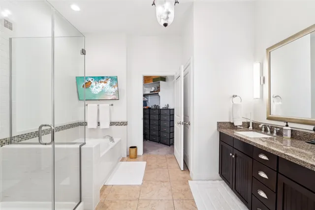 a spacious bathroom with a double vanity sink a mirror and a bathtub