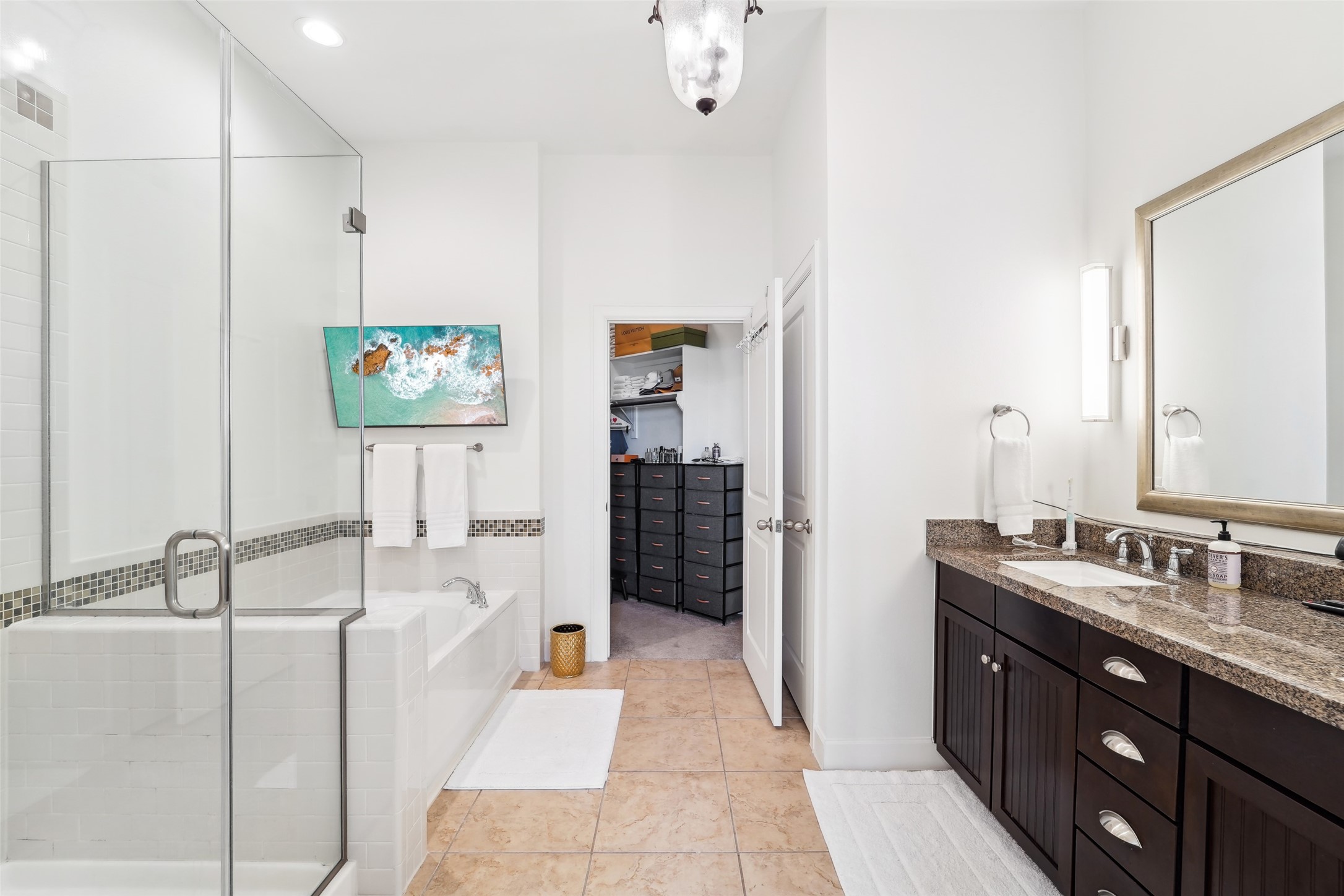 17040 West Fm 1097 Road, Unit 4101 Montgomery, TX 77356 - Photo 14 of 29 a spacious bathroom with a double vanity sink a mirror and a bathtub