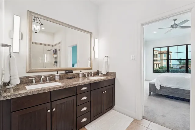 a en suite bathroom with a double vanity sink and a mirror