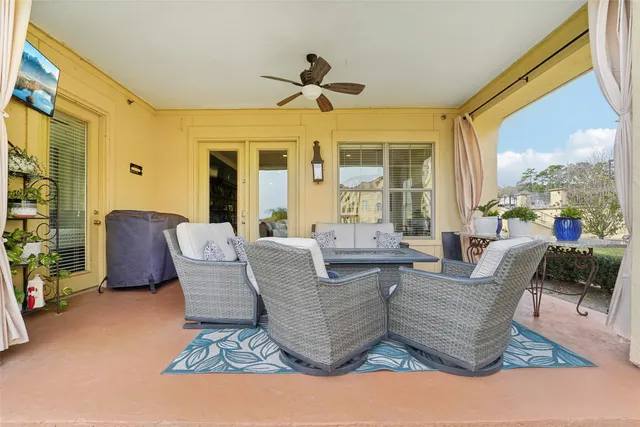 a living room with couches and a large window with garden view