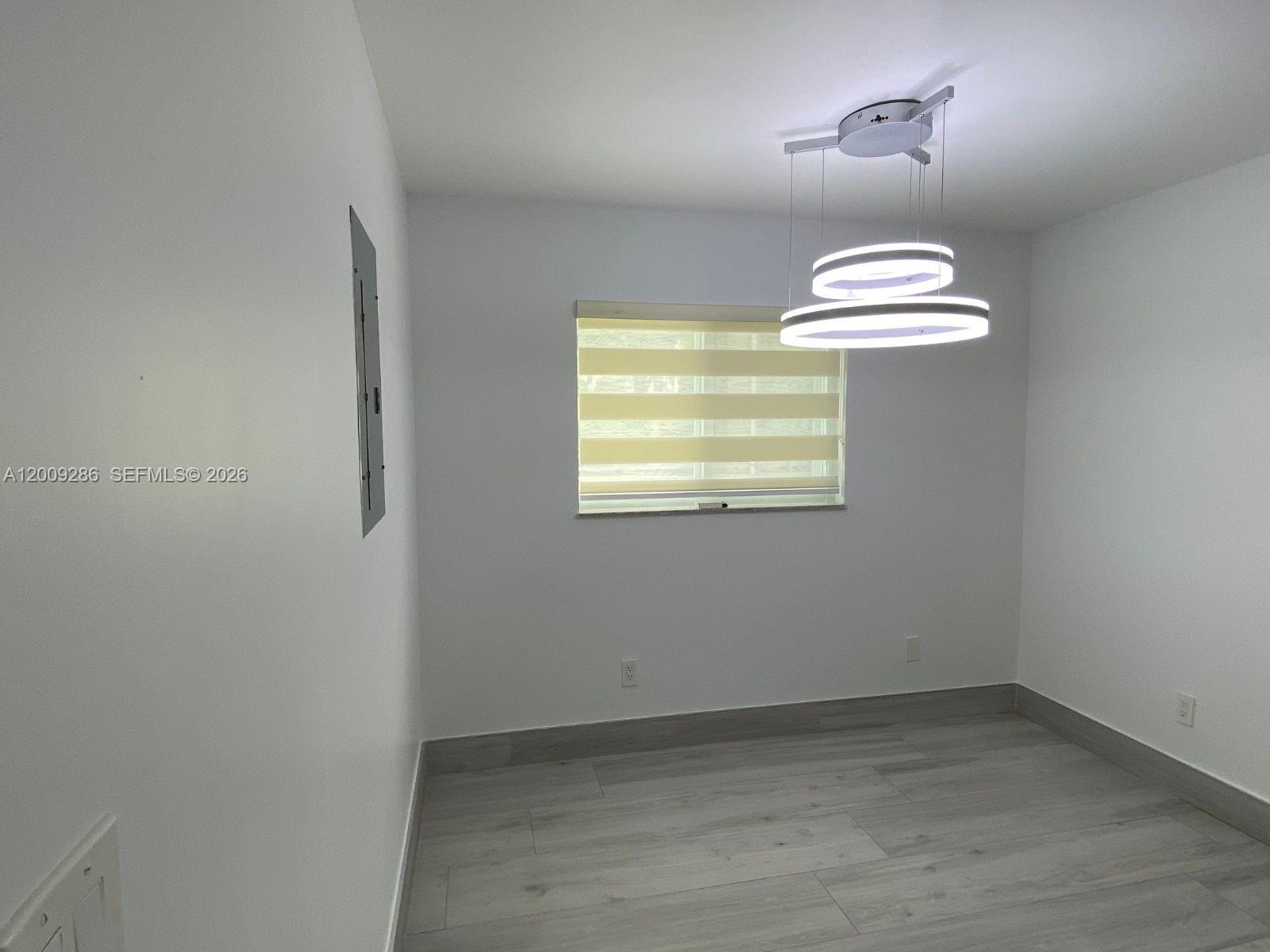403 Southwest 89th Place Miami, FL 33174 - Photo 15 of 39 an empty room with chandelier fan