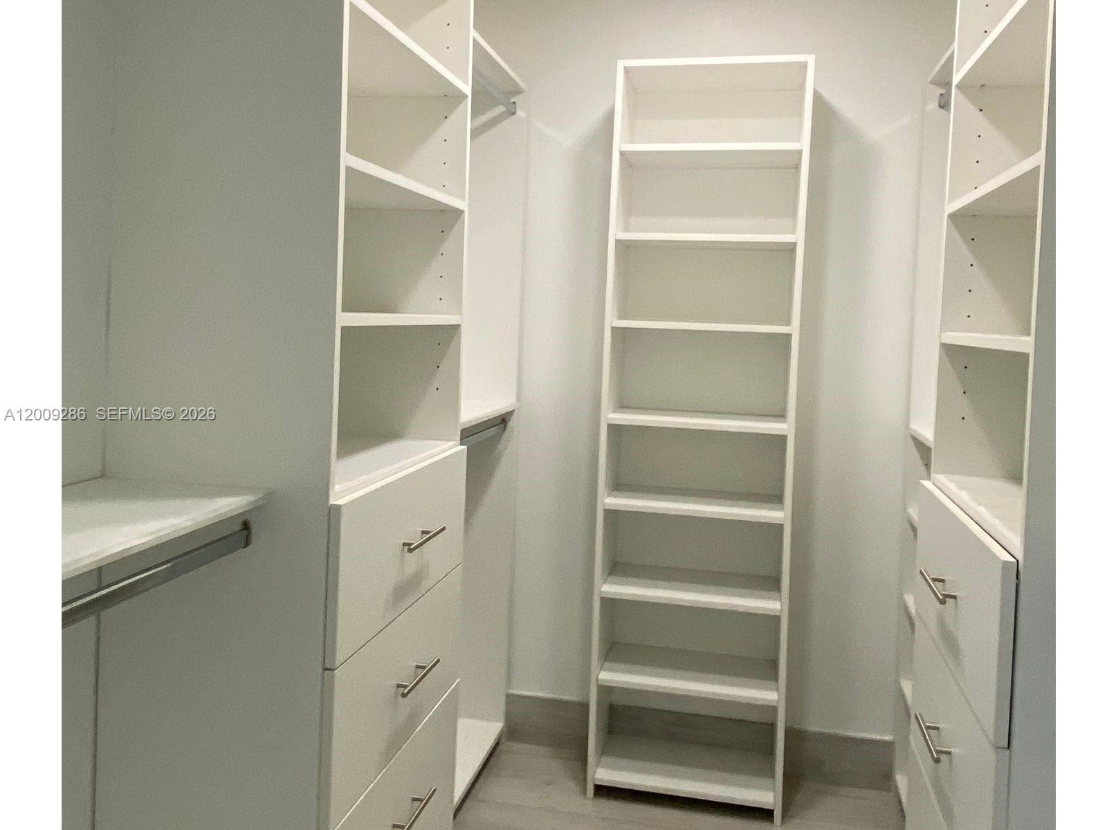 403 Southwest 89th Place Miami, FL 33174 - Photo 19 of 39 a view of walk in closet with empty racks