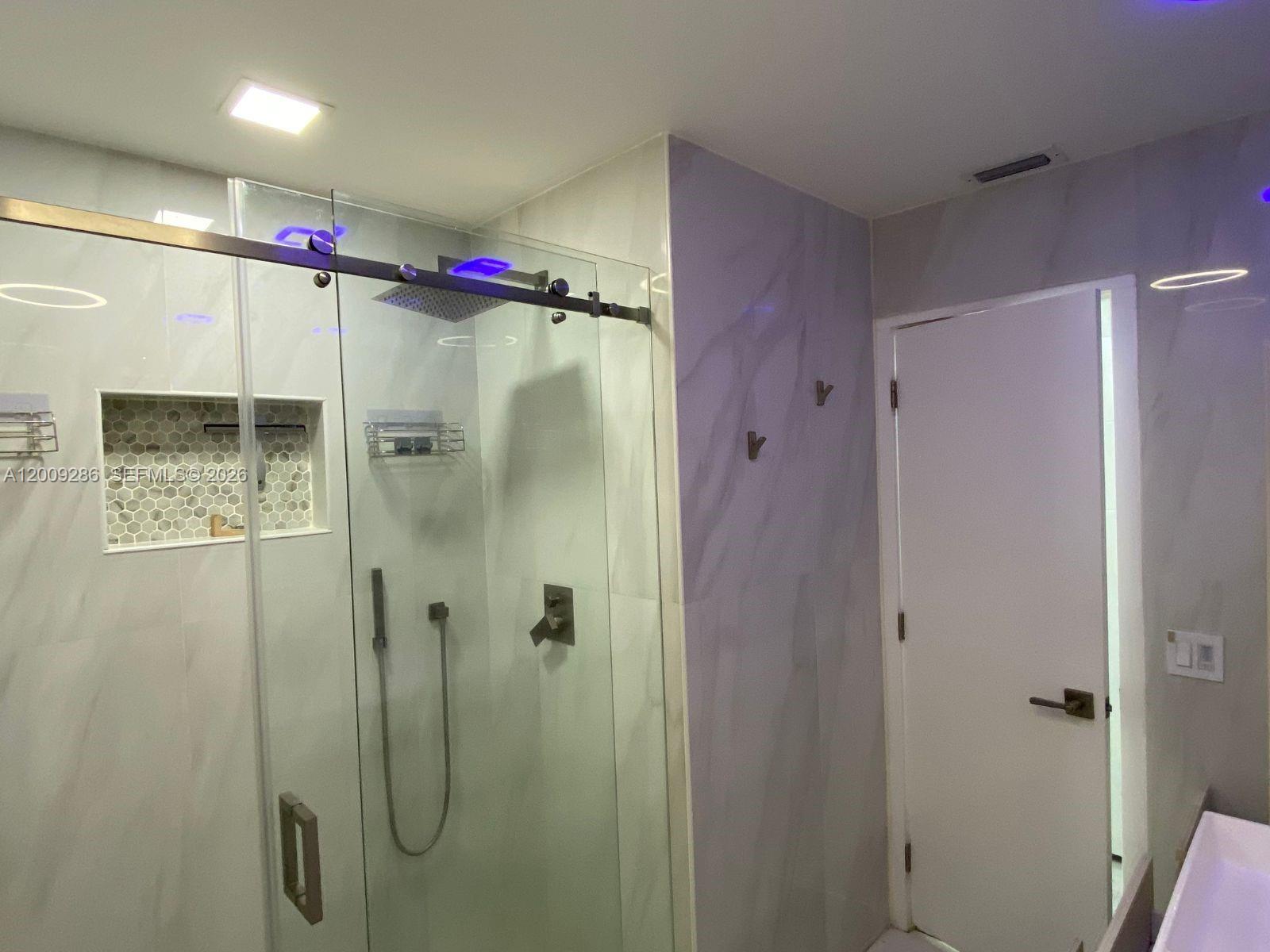 403 Southwest 89th Place Miami, FL 33174 - Photo 24 of 39 a bathroom with a shower and a mirror