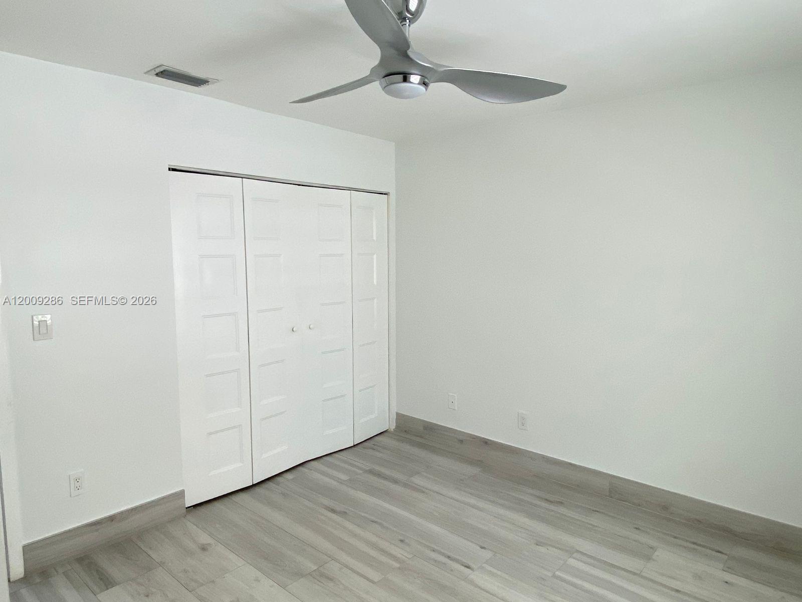 403 Southwest 89th Place Miami, FL 33174 - Photo 30 of 39 a view of an empty room with wooden floor