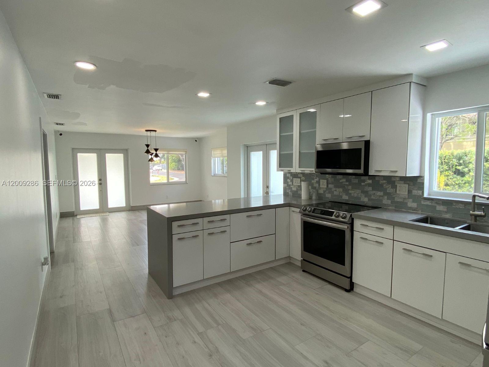 403 Southwest 89th Place Miami, FL 33174 - Photo 3 of 39 a large kitchen with stainless steel appliances granite countertop a stove and a sink