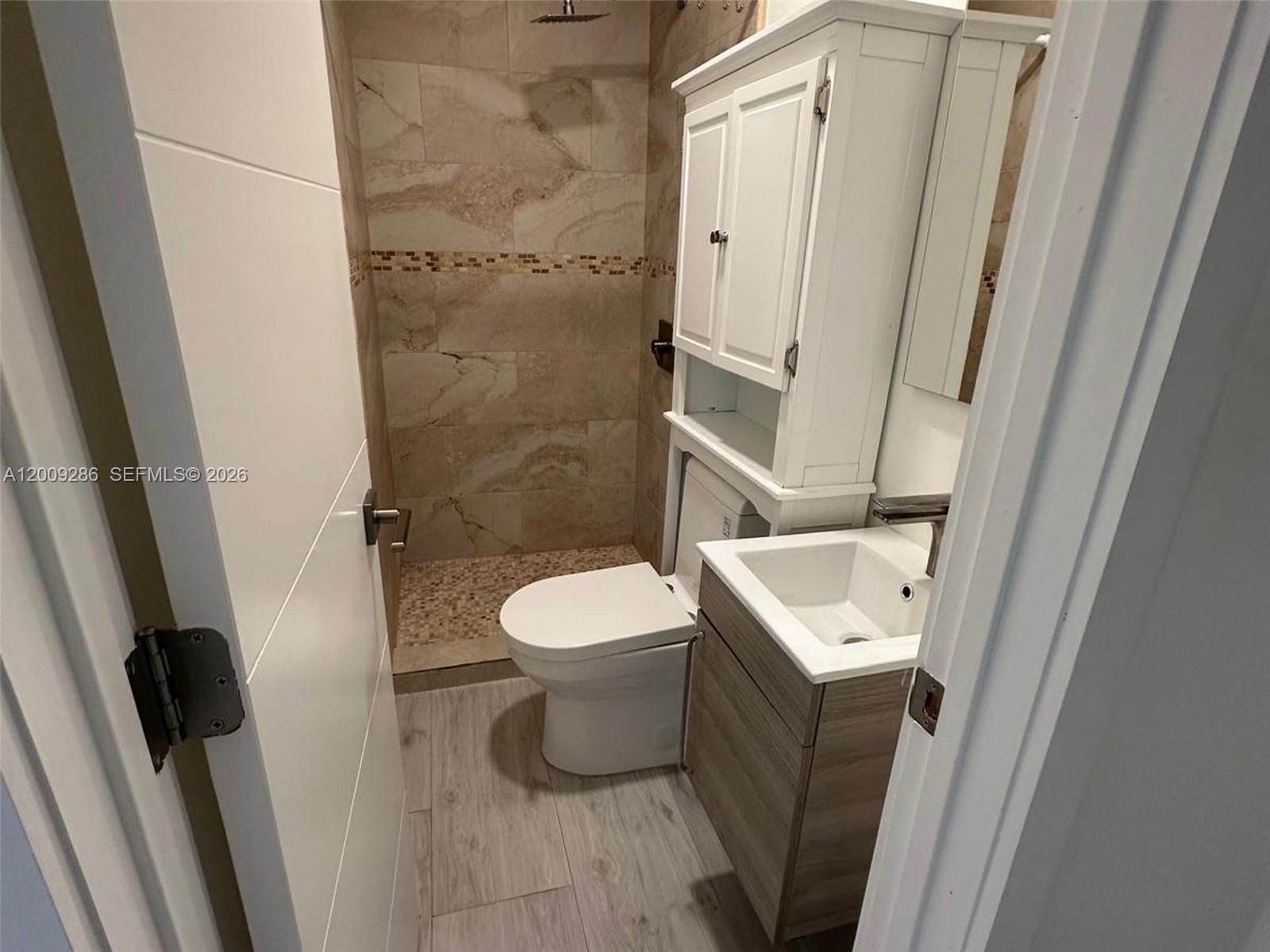 403 Southwest 89th Place Miami, FL 33174 - Photo 31 of 39 a white toilet sitting next to a bathroom sink