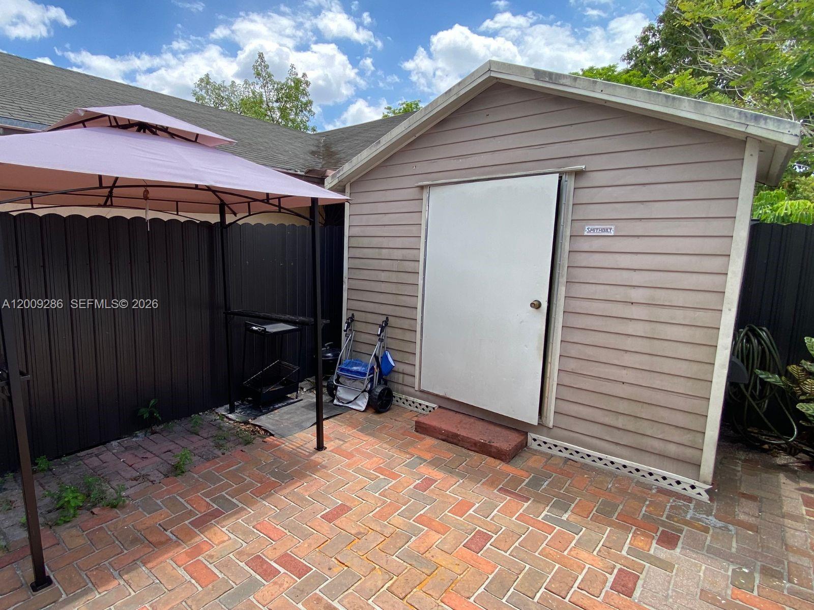 403 Southwest 89th Place Miami, FL 33174 - Photo 33 of 39 a backyard of a house with table and chairs
