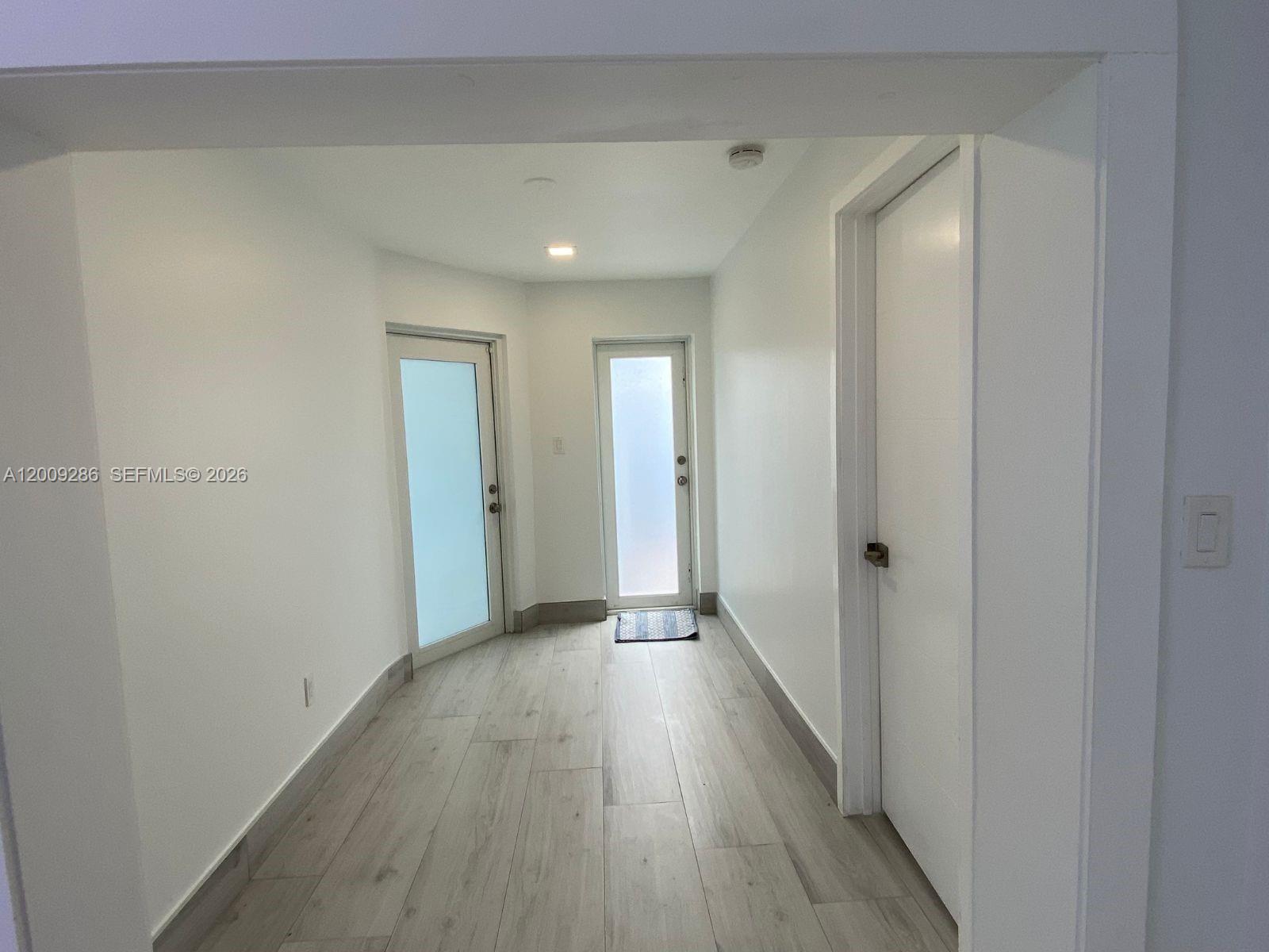 403 Southwest 89th Place Miami, FL 33174 - Photo 7 of 39 a view of a hallway with wooden floor