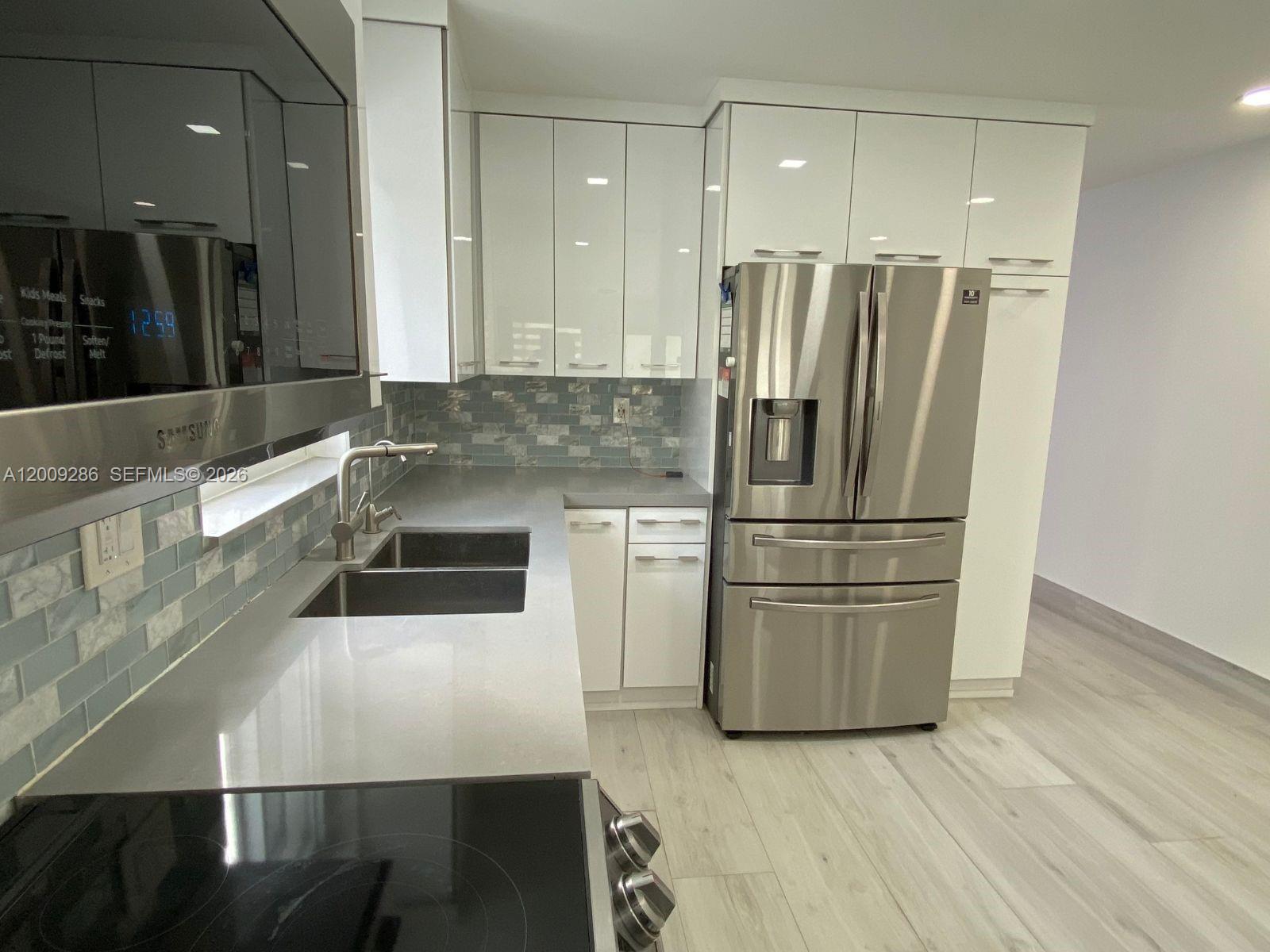403 Southwest 89th Place Miami, FL 33174 - Photo 8 of 39 a kitchen with stainless steel appliances a refrigerator and a sink