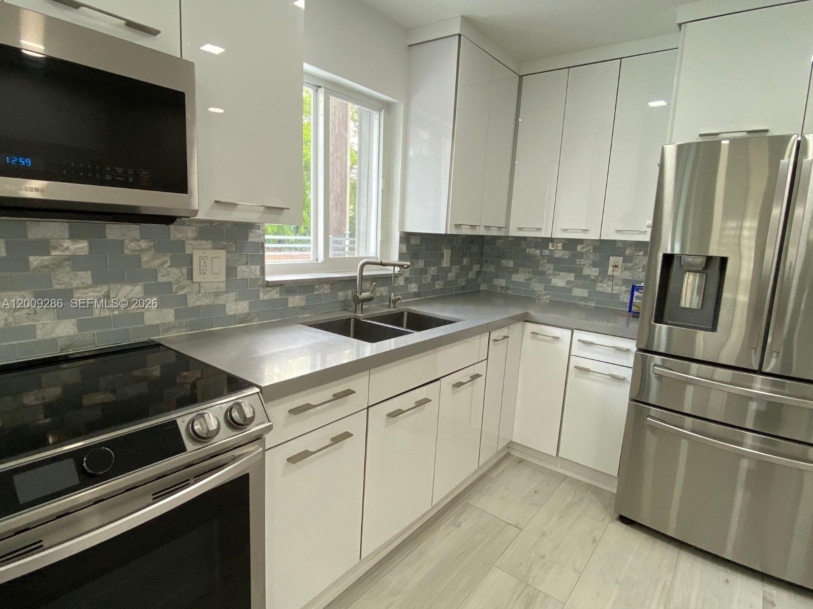 403 Southwest 89th Place Miami, FL 33174 - Photo 9 of 39 a kitchen with a refrigerator stove and sink