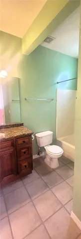 a bathroom with a granite countertop bathtub and sink