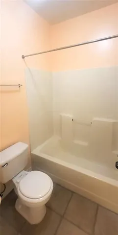 a bathroom with a toilet and a bathtub