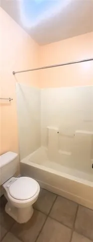 a bathroom with a toilet and a bathtub