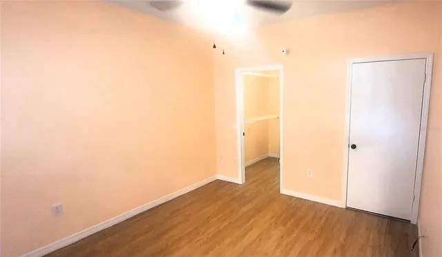 a view of a room with wooden floor