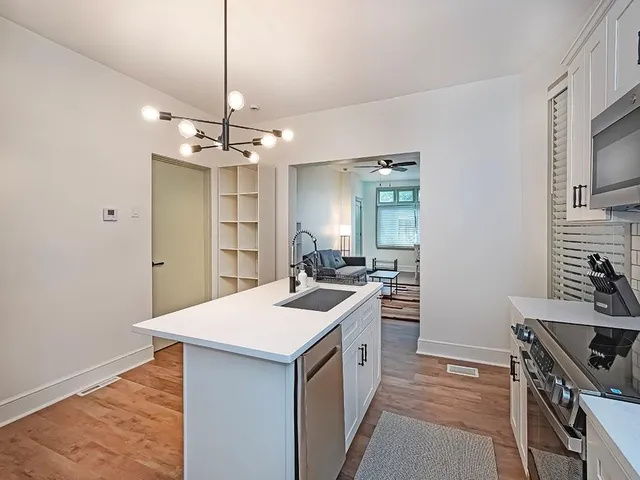 a kitchen with a sink stove and refrigerator