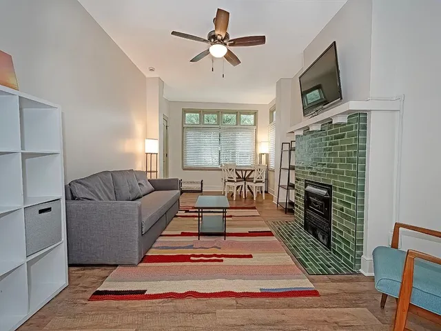 a living room with furniture wooden floor and a fireplace