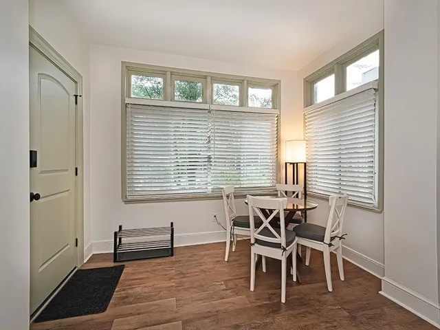 a view of a dining room with furniture and windows