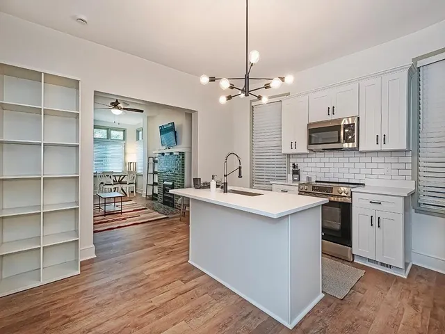 a kitchen with stainless steel appliances a stove sink and microwave