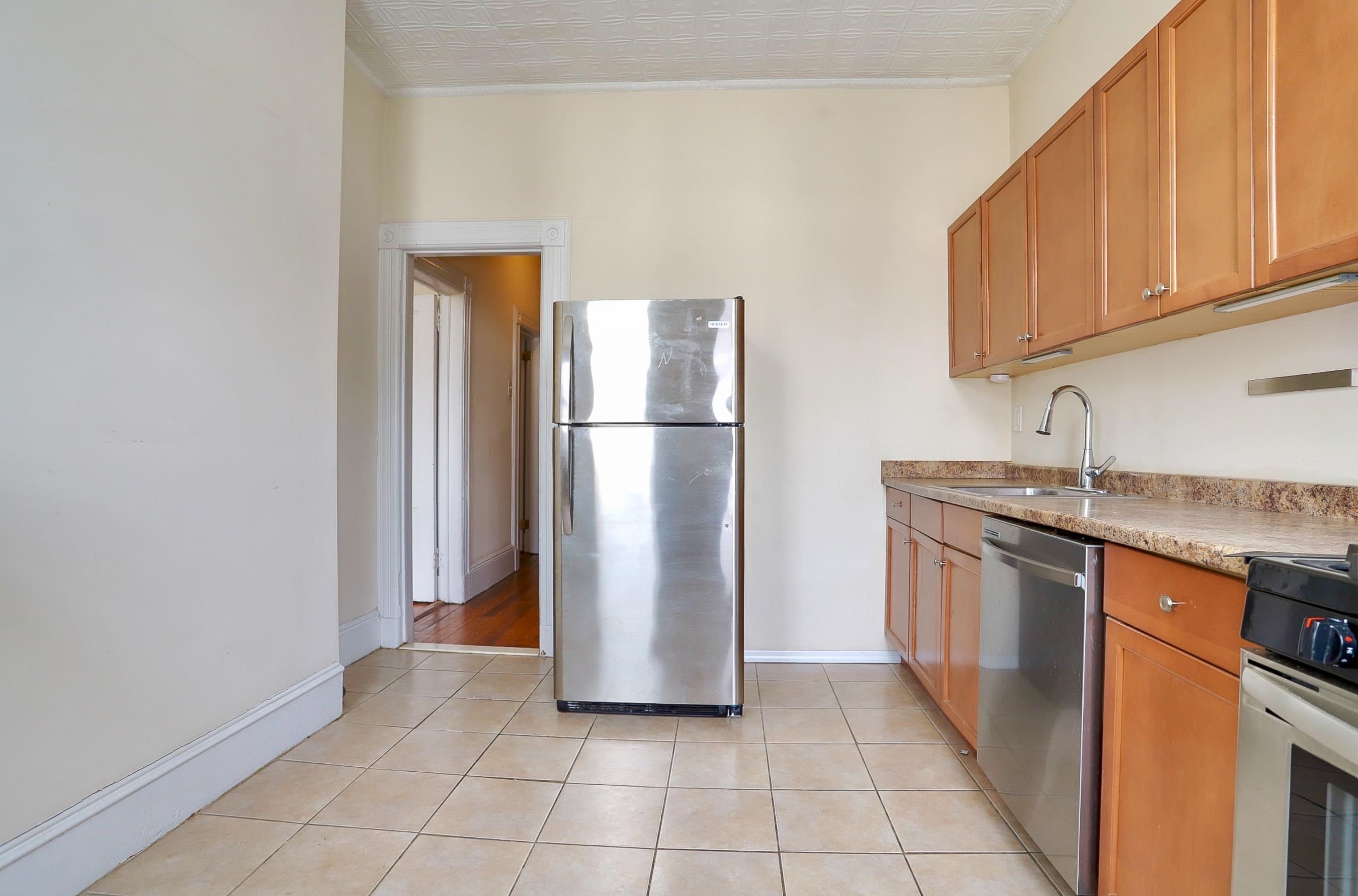 58 Prospect Street, Unit 2 Jersey City, NJ 07307 - Photo 11 of 26 a kitchen with a refrigerator sink and cabinets