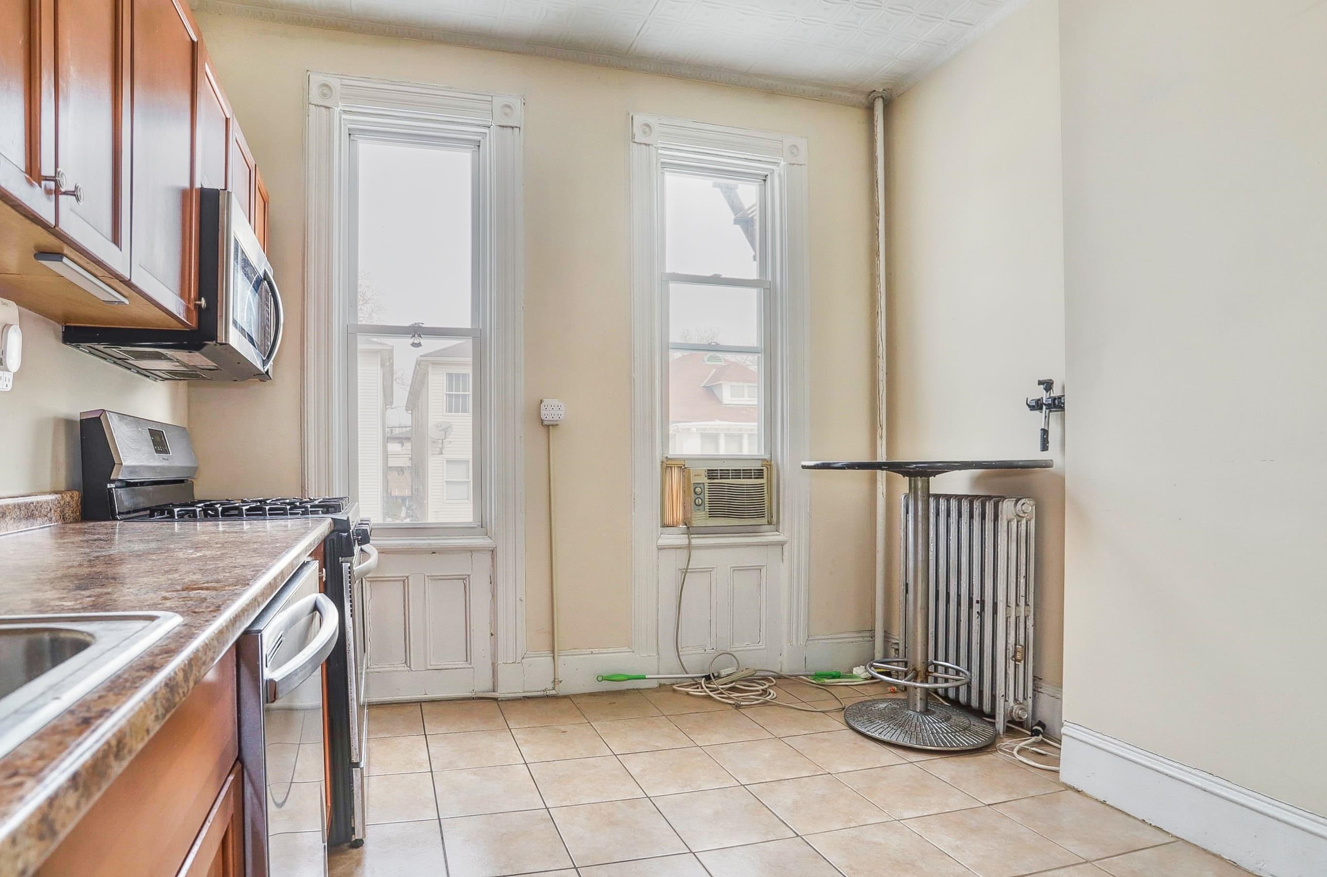 58 Prospect Street, Unit 2 Jersey City, NJ 07307 - Photo 12 of 26 a kitchen with a sink a stove and a refrigerator
