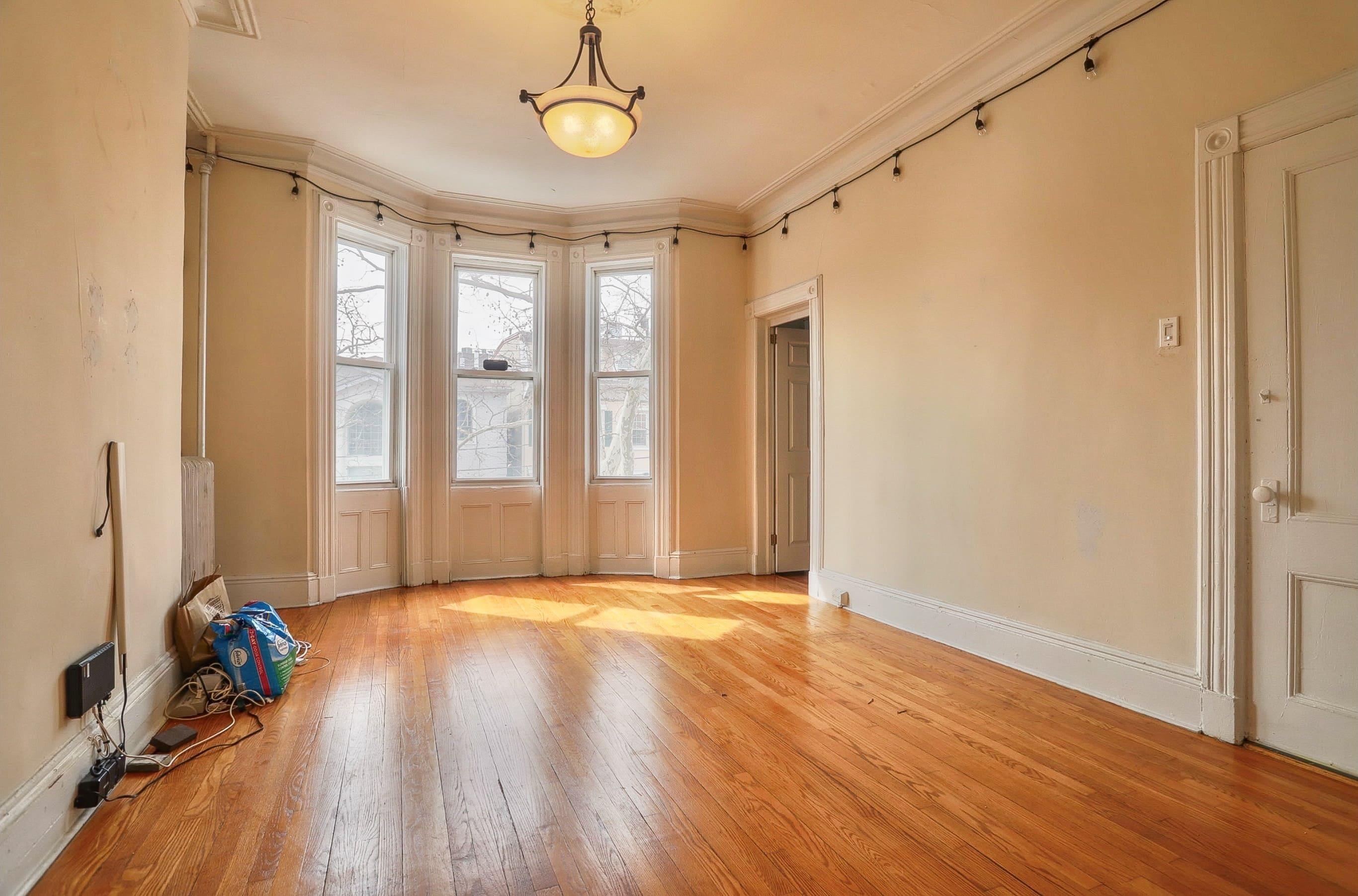 58 Prospect Street, Unit 2 Jersey City, NJ 07307 - Photo 2 of 26 a view of an empty room with wooden floor and a window