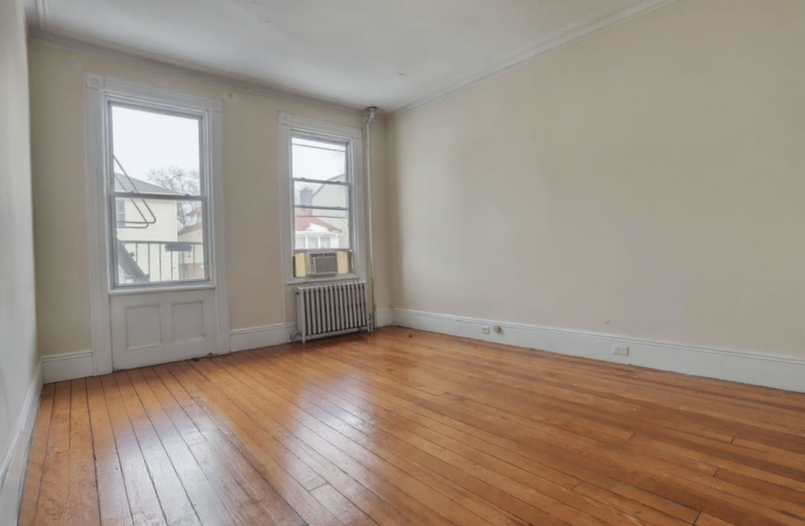 58 Prospect Street, Unit 2 Jersey City, NJ 07307 - Photo 23 of 26 an empty room with wooden floor and windows