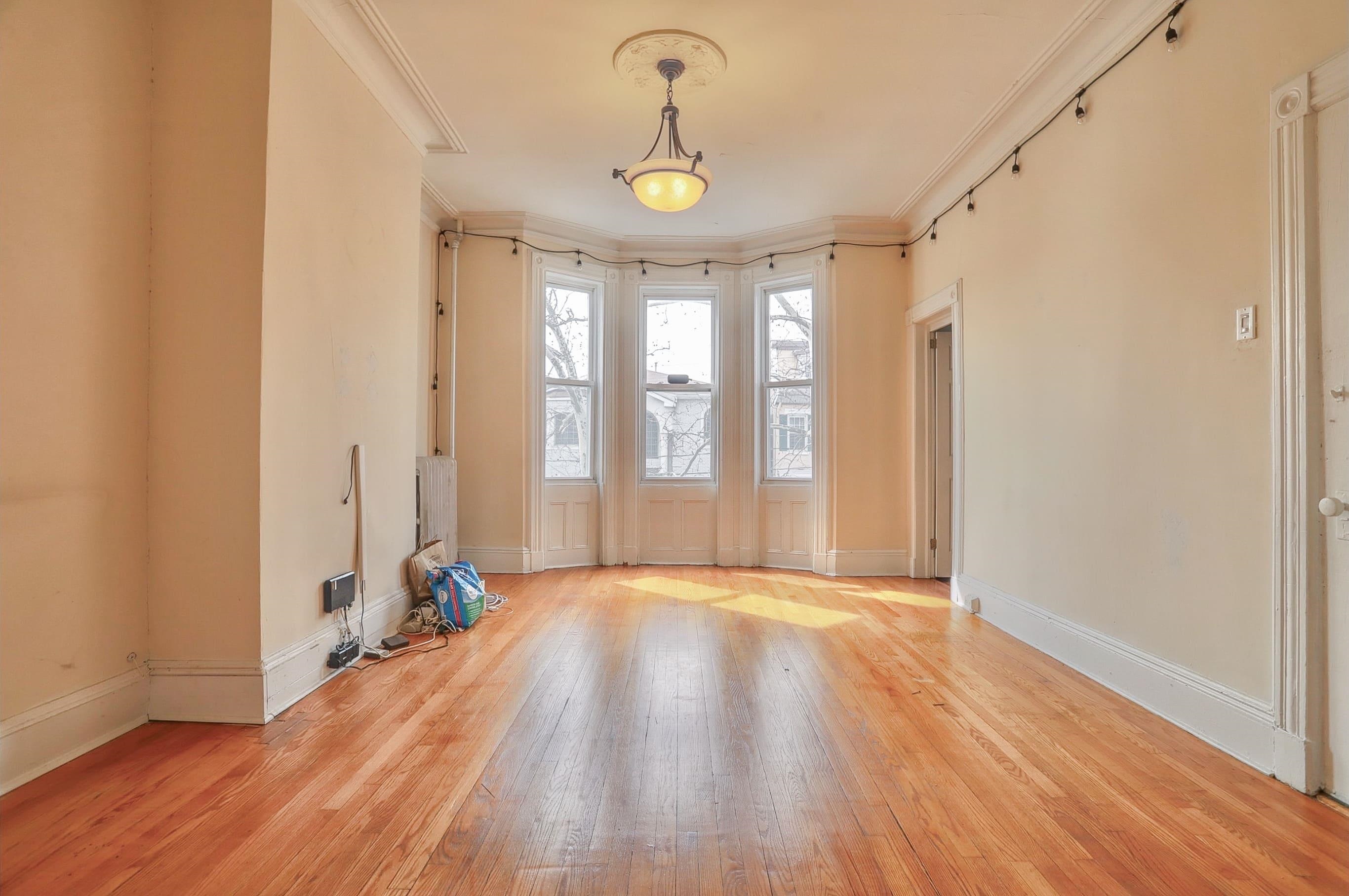 58 Prospect Street, Unit 2 Jersey City, NJ 07307 - Photo 3 of 26 a view of an empty room with window and wooden floor