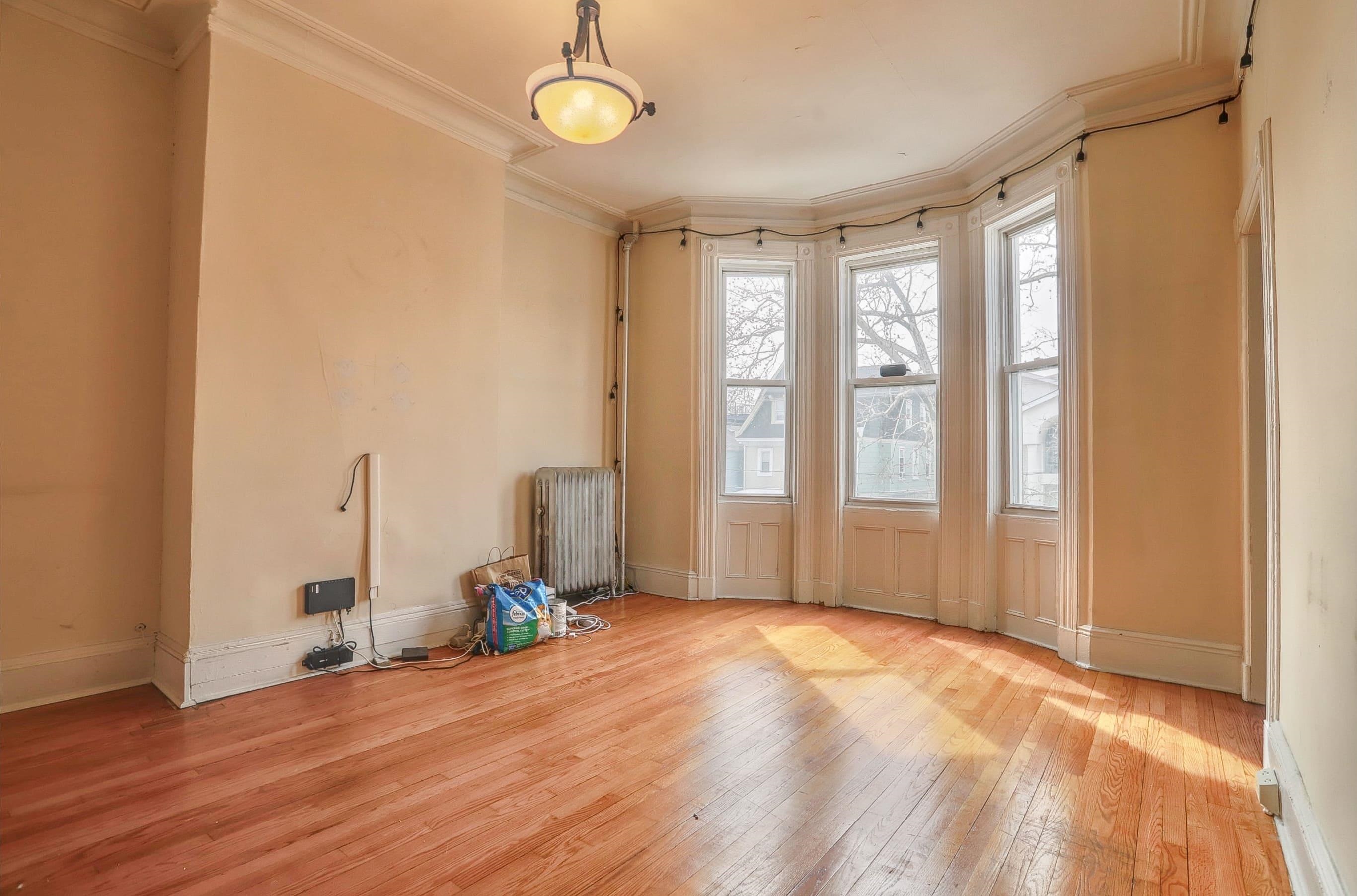 58 Prospect Street, Unit 2 Jersey City, NJ 07307 - Photo 4 of 26 a view of empty room with wooden floor and fan