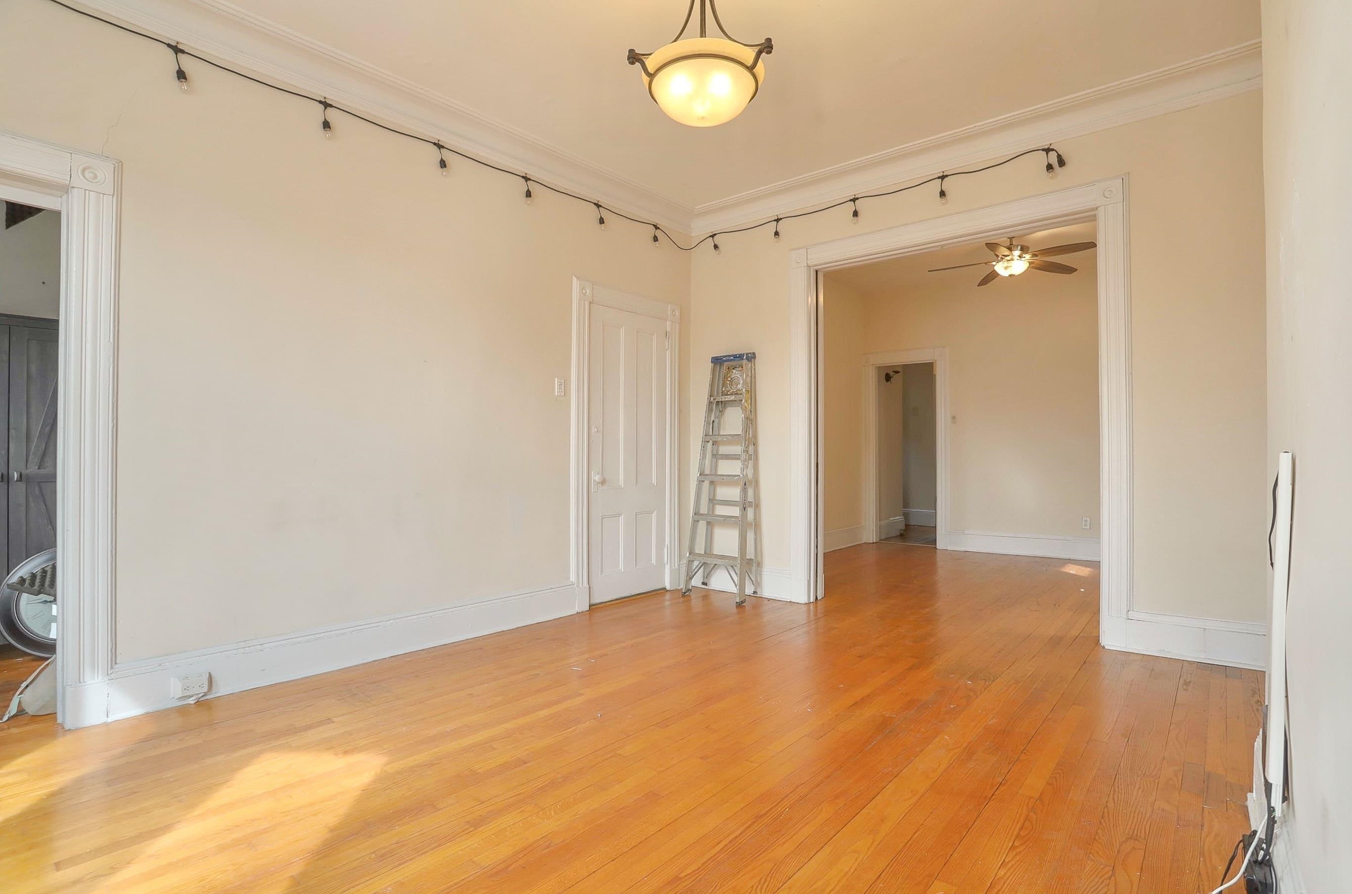 58 Prospect Street, Unit 2 Jersey City, NJ 07307 - Photo 6 of 26 a view of an empty room with wooden floor and a window