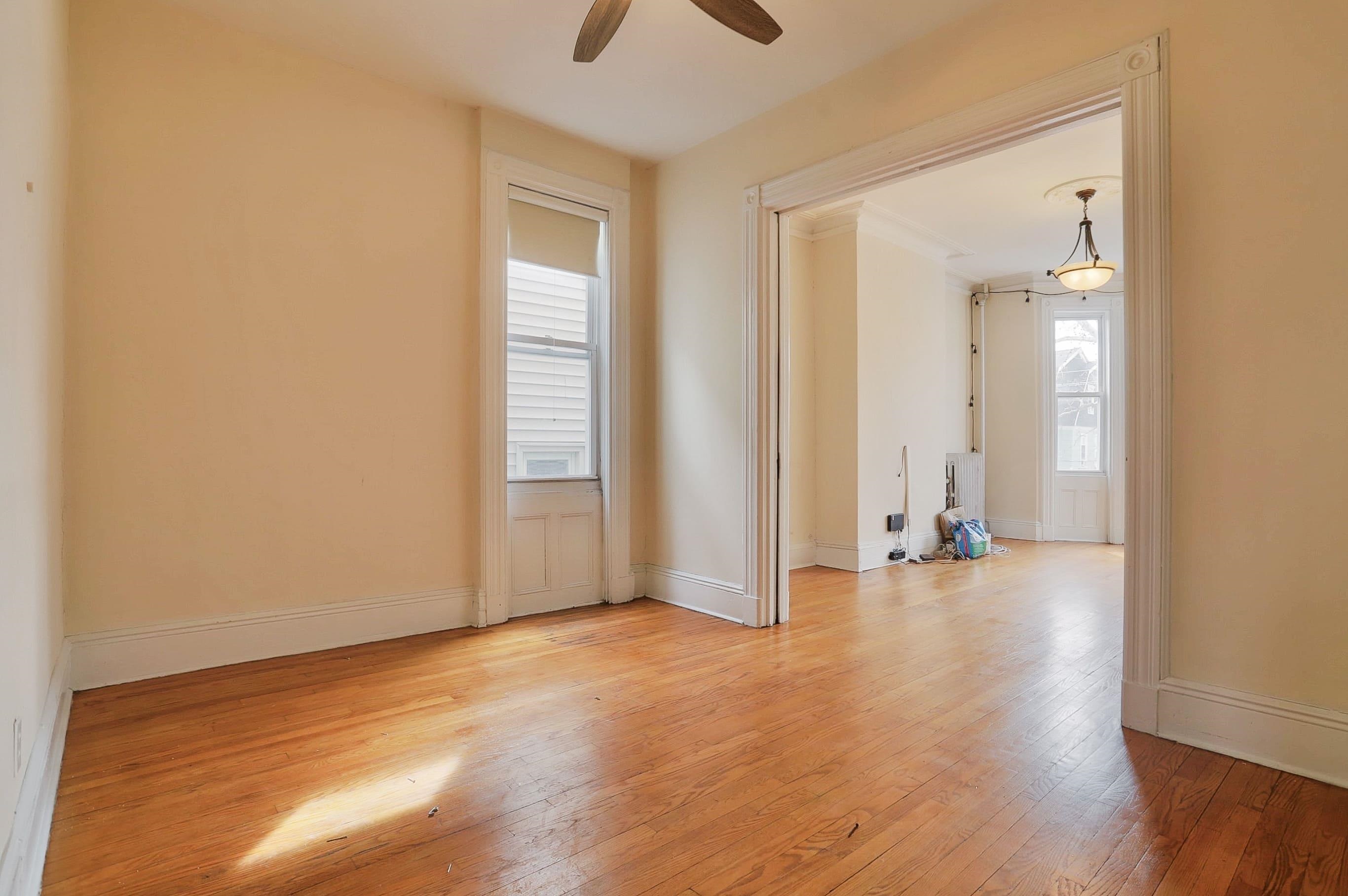 58 Prospect Street, Unit 2 Jersey City, NJ 07307 - Photo 9 of 26 an empty room with wooden floor and windows