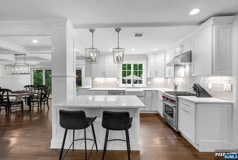 a kitchen with a refrigerator a stove a microwave and cabinets